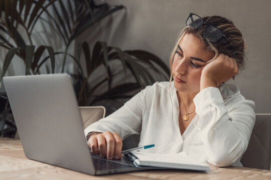 Bored Caucasian Young High School Student Tired Of Learning Doing Homework Reading Book, Blonde Teenager Girl Studying Preparing For Exam Test, Literature Research, Employee Working Concept.