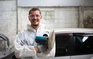 auto mechanic worker painting, automobile repairman painter in protective workwear and respirator...