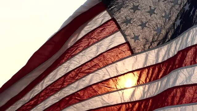 Happy 4th of July USA Independence Day, United States of American flag waving in wind against sun nature outdoor background, Slow Motion. Fourth of July, Memorial Day, Veterans Day, Labor Day Concept