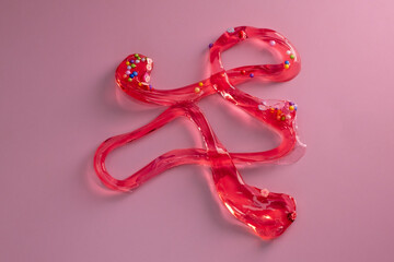 Colorful gel texture, clear skincare cream with bubbles and decorative figurines background, transparent beauty serum, colored cosmetic product close up