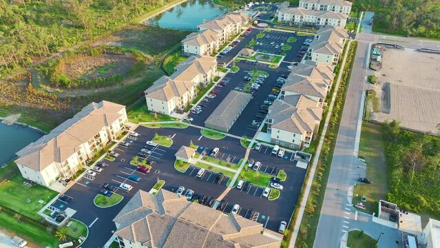 Aerial view of american apartment buildings in Florida residential area. New family condos as example of housing development in US suburbs
