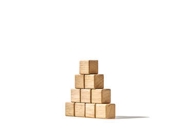 Fototapeta premium Wood cubes arranged in the pyramid shape on white