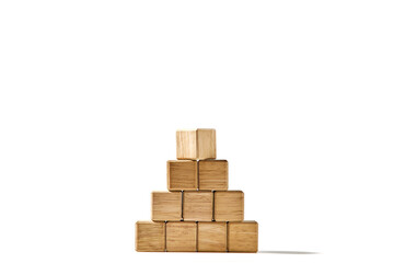 Wood cubes arranged in the pyramid shape on white