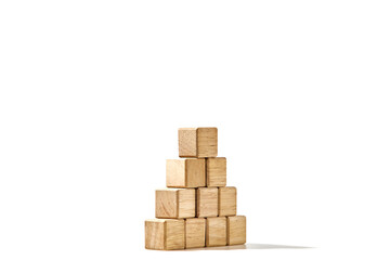 Wood cubes arranged in the pyramid shape on white