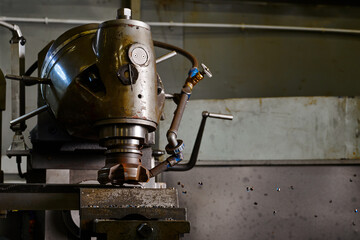 Old vertical milling machine in plant workshop closeup