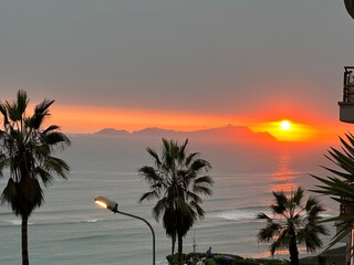 sunset over the pacific at barranco in lima