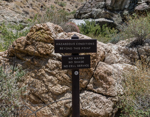 Hazardous conditions beyond this point sign along the Palm Canyon trail in Palm Springs, Southern California 