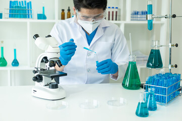Researcher with chemical test tubes in a glass laboratory with liquid for analytical, medical, pharmaceutical and scientific research concepts Test tubes in medical research clinics and chemicals