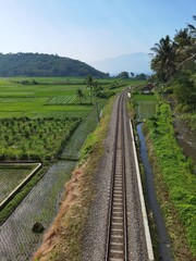 Obraz na płótnie Canvas Between the railroad, rice fields and rivers