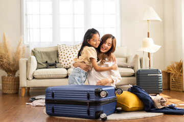 Portrait of happy love asian family mother with little girl traveler packing stuff and outfit...