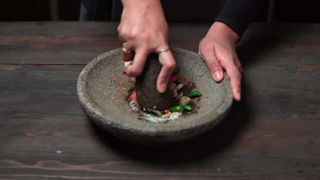 Close up the chef is pounding chili sauce. Sambal is a famous food from Indonesia
