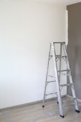 Aluminium ladder in empty room of new house for technician use to higher jobs. Image with copy space © zilvergolf