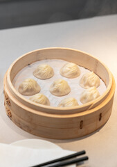 Close-up of soup dumpling in basket on table meal