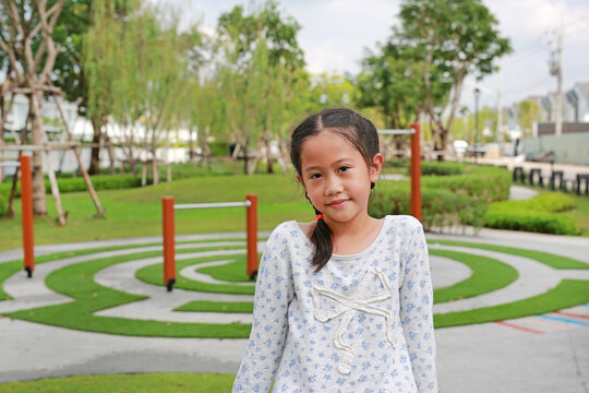 Cute Asian girl kid in the garden at public park outdoor.