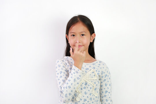 Portrait of Asian girl kid touch or point her nose isolated on white background.