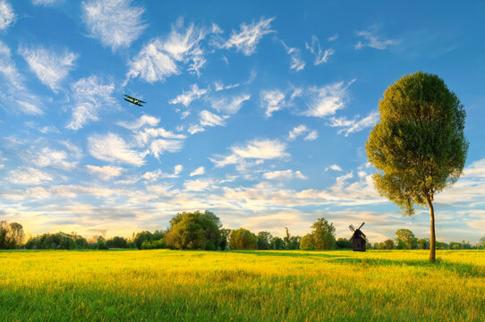 The plane is flying over the vast grassland.