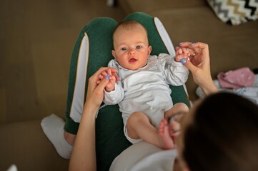 Portrait of mother playing with her little baby girl