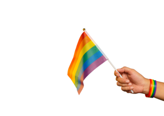 Rainbow flag and wristband in hand against a transparent background