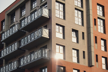 Modern office building exterior with glass facade on clear sky background. Transparent glass wall of office building with yellow decoration. Abstract Structure Element of facade of modern European