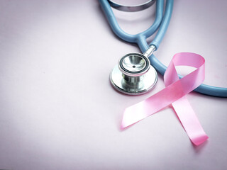 Fototapeta na wymiar Breast cancer awareness pink ribbon with doctor stethoscope on pink background, october symbol, healthcare and medicine concept