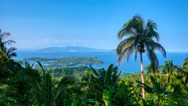 Wide angle view of the Philippines coastal resort area of Puerto Galera on Mindoro Island, the Verde Island Passage, and Luzon Island in the distance.
