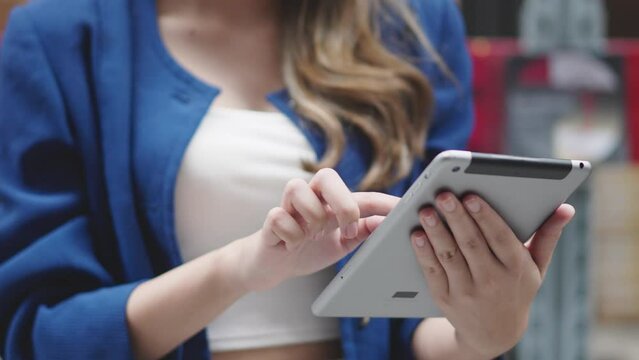 Asian woman using tablet looking up stock taking inventory in factory. logistic business shipping and delivery logistic service.