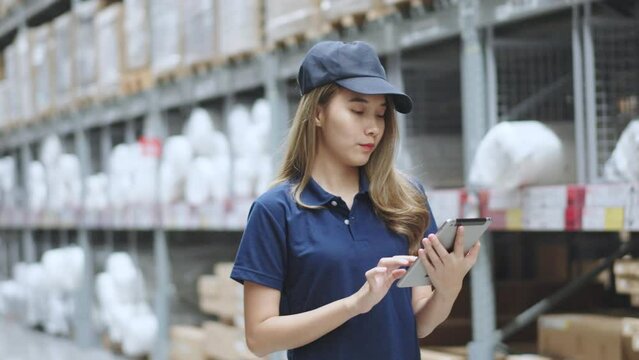 Asian female using tablet checking amount of stock product inventory on shelf at distribution warehouse factory. logistic business shipping and delivery logistic service.