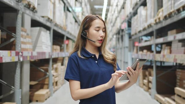 Asian female using tablet checking amount of stock product inventory on shelf at distribution warehouse factory. logistic business shipping and delivery logistic service.