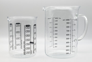 Empty glass measuring cup isolated on white background