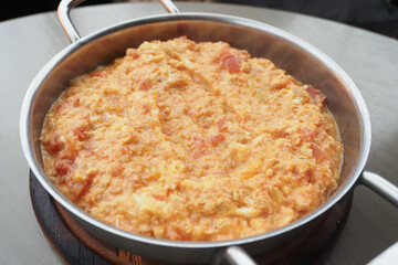 Turkish Menemen omelet in a frying pan. .