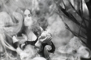 Woman in a witch suit in a dense forest