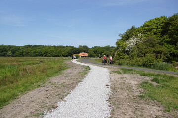 Hikers and cyclists on the shell walking path and cycle path (called Paddenpad) in the Dutch...