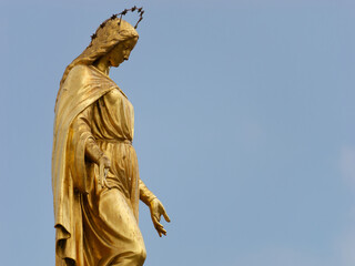 Close-up photo of a Holy Mary on top of a column with angels placed in front of Zagreb Cathedral in Kaptol, Zagreb, Croatia	