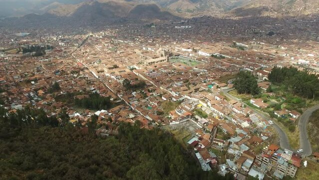 Aerial - Forward tilt down on historical city of cusco, peru. High altitude shot