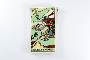 Tarot cards, Rider Waite tarot cards, the knight of swords vintage card in the foreground.