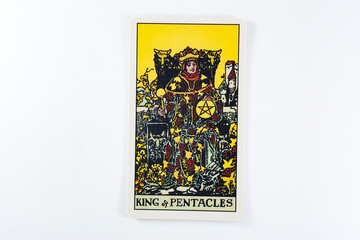 Naklejka na ściany i meble Tarot cards, Rider Waite tarot cards, the king of pentacles vintage card in the foreground.