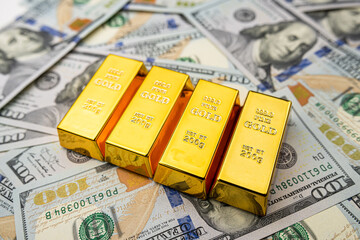 Gold bullion over 100 us dollar money, investment and wealth concept