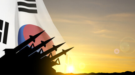 The missiles are aimed at the sky with South Korea flag against the sunset. EPS10 vector