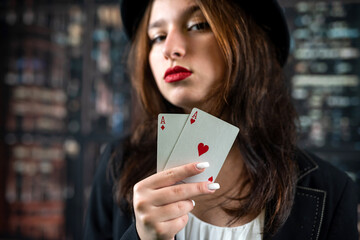 Casino woman with red lips holding ace with seductive lips and teeth. face close up