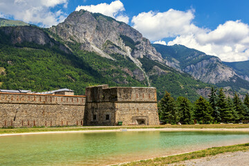 Fototapeta na wymiar Small artificial lake and old fortress in Vinadio, Italy.