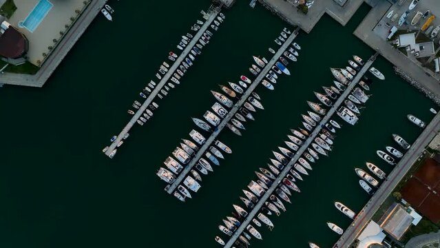 Aerial photography from a drone on top of many yachts and boats in the harbor. The drone smoothly rotates around its axis. Mediterranean Sea, Alanya,Turkey