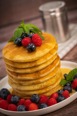 Recipe for maple syrup pancakes with raspberry and blueberry filling, High quality photo