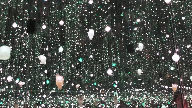 Mesmerizing display of twinkling lights creates a captivating illusion in an infinity mirror room