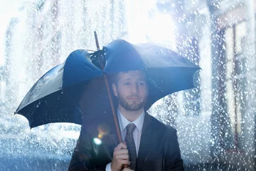 Fotobehang Frustrated businessman with broken umbrella in rain © KOTO