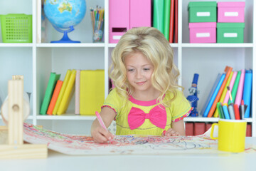 girl drawing picture at desk at home