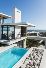 Lap pool and balcony of modern house overlooking ocean