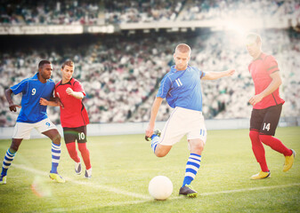 Soccer player kicking ball on field