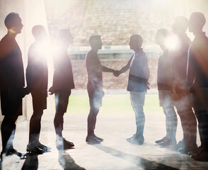 Silhouette of soccer teams shaking hands