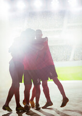 Silhouette of soccer team celebrating