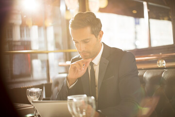 Businessman using digital tablet in restaurant